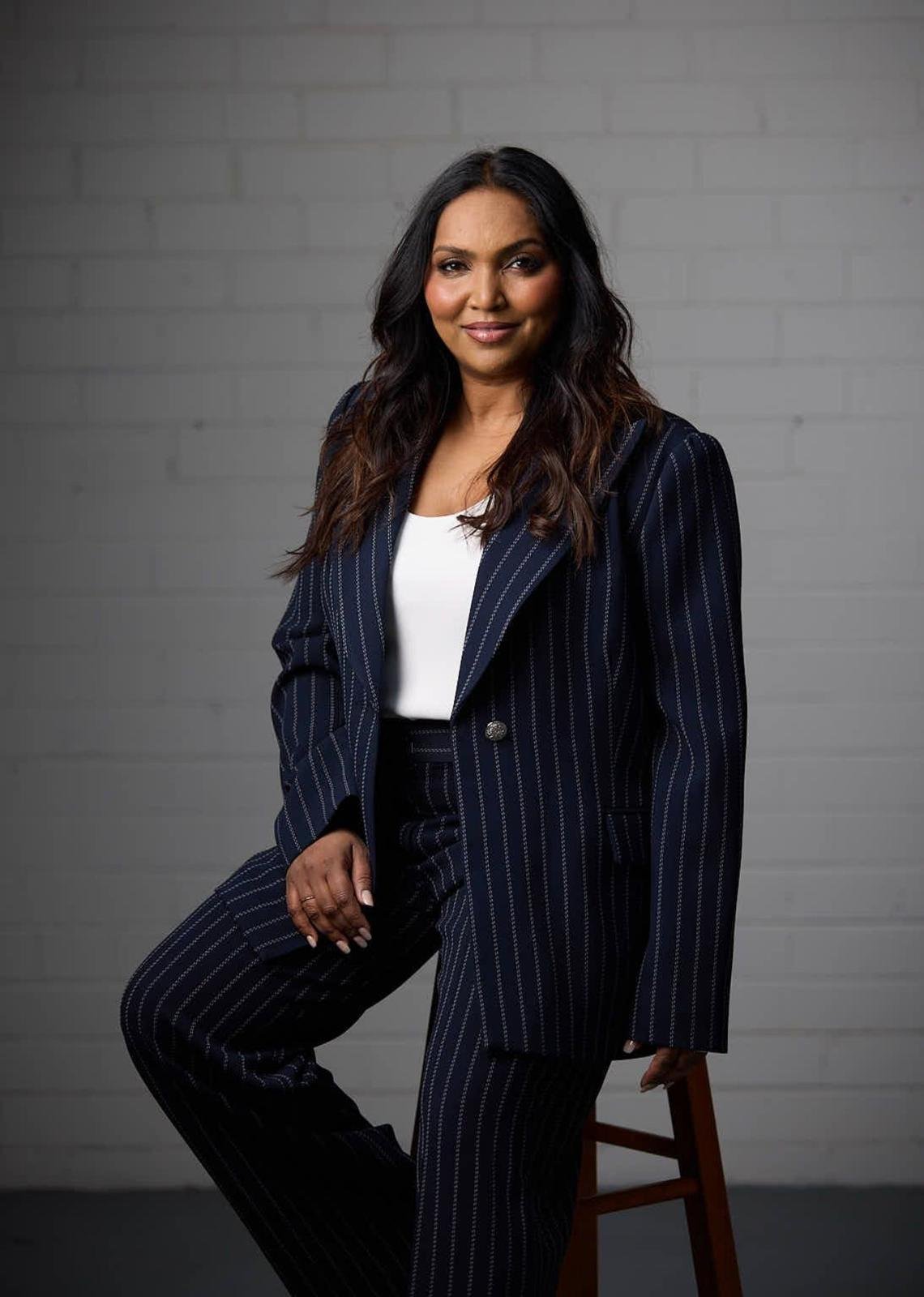 Norliza, international keynote speaker in navy pinstripe suit